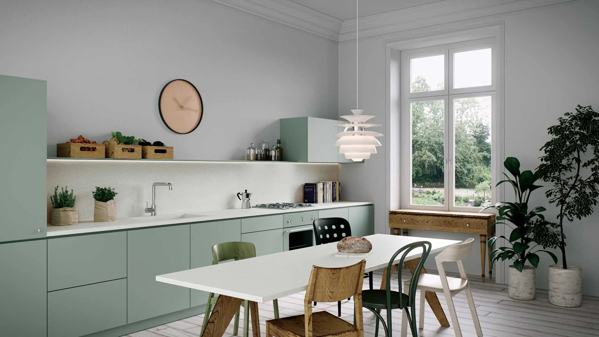 Modern kitchen with mint-green cabinets, Caesarstone countertop, and dining table with mixed wood and metal chairs in a bright, natural setting.